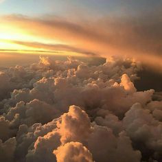 the view from an airplane looking down at clouds