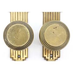 two antique brass door knobs on white background