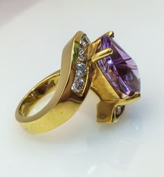 Birmingham Jewelry Fashion Ring with a Beautiful Amethyst gemstone 18K Yellow Gold Amethyst: 6.11ct Diamond: 10 round stones 1.10tw Size: 6.00 Formal Purple Sapphire Ring With Gemstone Accents, Luxury Lavender Amethyst Ring With Center Stone, Yellow Gold Amethyst Ring With Round Cut Accent Stones, Yellow Gold Amethyst Ring With Accent Stones, Round Cut, Formal Purple Diamond Ring With Gemstone Accents, Anniversary Amethyst Ring With Brilliant Cut, Luxury Lavender Amethyst Ring For Formal Occasions, Luxury Lavender Amethyst Ring For Anniversary, Luxury Lavender Round Ring