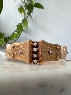 "Offered here is a stunning antique 18k gold Victorian era seed Pearl and hand engraved floral design bracelet.  Absolutely beautiful, wear consistent with age, (Circa 1880) it is slightly not symmetrical, has numerous small dents etc.   Measurements are approximately 7\" circumference, Clasp works well and snaps closed with a safety chain. The front of the cuff measures just under 3/4\" across and the back is just under 1/2\" across.  WEIGHT:  15.2 grams  METAL: yellow 18k Gold ,unlegible marke Design Bracelet, Safety Chain, Seed Pearl, Hand Engraving, Antique Victorian, Victorian Era, Bracelet Designs, Pearl Bracelet, Cuff Bracelets