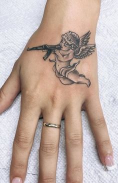 Angle With Ak47 Tattoo, Angel Hand Tattoo, Hase Tattoos, Cupid Tattoo, Basic Tattoos, Hand And Finger Tattoos, Pretty Hand Tattoos, Neck Tattoos Women, Small Pretty Tattoos