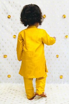 Mustard yellow kurta featuring multi-colored lotus motif embroidery and a band collar. Paired with plain pyjama featuring an elasticated waistband., Fit: Relaxed Lotus Silk, Yellow Lotus, Lotus Motif, Yellow Kurta, Motif Embroidery, Boys Kurta, Yellow Silk, Band Collar, Pyjama Set