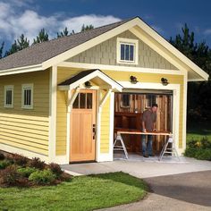 a man standing in front of a yellow garage