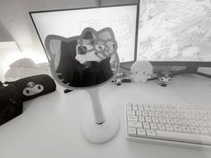 a desk with a keyboard, monitor and mouse on it in front of the screen