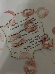 there is a piece of paper that has lipstick imprints on it and the words written in different languages