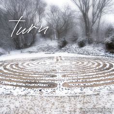 a snow covered garden with trees in the background and text that reads, turs