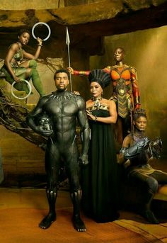 the cast of black panther pose for a photo in front of an artistic backdrop with people dressed as superheros