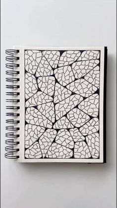 a notebook with black and white designs on it