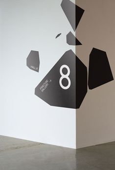 an image of the number eight in black and white on a wall with geometric shapes