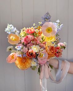 a person holding a bouquet of flowers in their hand