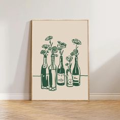 three bottles with flowers in them are sitting on the floor next to an empty wall