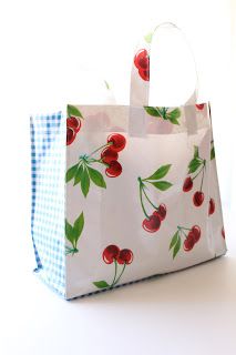 a white bag with red cherries on it