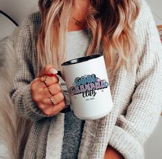 a woman holding a coffee mug with the words good grandma on it in front of her