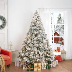 a white christmas tree with presents under it