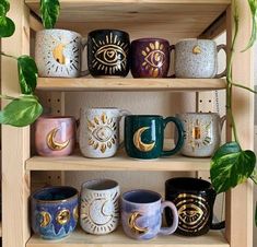 a wooden shelf filled with lots of different colored coffee mugs