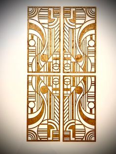 an art piece made out of wood with geometric designs on the wall in front of it