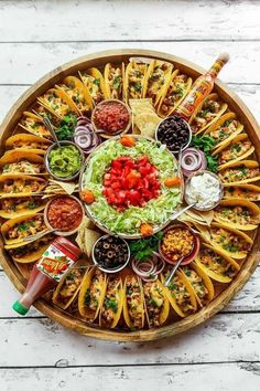 a platter filled with tacos and condiments