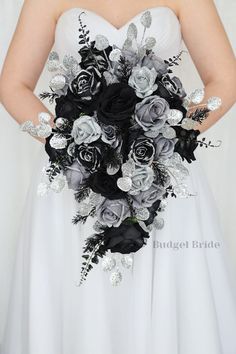 a bridal holding a bouquet of black and silver flowers