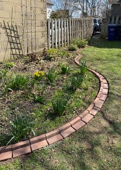 a brick garden edging in front of a house