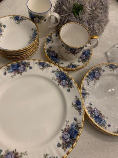 a table topped with plates and cups filled with flowers