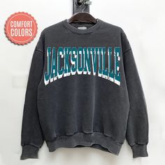 "comfort colors Jacksonville Football sweatshirt, Jacksonville Football Shirt, Jacksonville Football Gift -Please check Color and Size Charts before placing the order. You can find them in the listing's photos (Depending on what device you are viewing this listing colors may vary slightly). -Returns and exchanges are accepted only if there are defects \"No Extra Costs\" We create custom t-shirts with great designs for everyone's liking. If you don't find the size or color you would like, please message us and we will be happy to  accommodate! comfort colors Jacksonville Football sweatshirt, Jacksonville Football Shirt, Jacksonville Football Gift PRODUCT Sweatshirt Comfort Colors® 1566     80% ring-spun cotton, 20% polyester     Medium-heavy fabric (9.5 oz /yd² (322.1 g/m     Relaxed fit Casual Soft-washed Sweatshirt For College, Gray Casual Sweatshirt With Lettering, Casual Gray Sweatshirt With Lettering, Gray Lettering Casual Sweatshirt, Blue Casual Sweatshirt With Lettering, College Crew Neck Soft-washed Sweatshirt, College Soft-washed Relaxed Fit Sweatshirt, Soft-washed Crew Neck Sweatshirt For College, College Relaxed Fit Soft-washed Sweatshirt