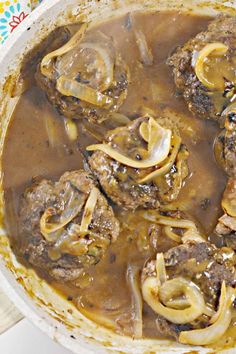 a pot filled with meat and mushrooms covered in gravy on top of a table