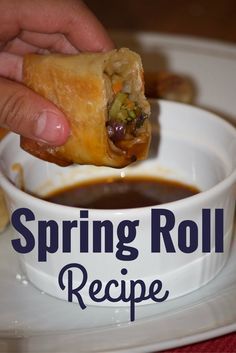 a person dipping some food into a bowl with sauce on the side that says spring roll recipe