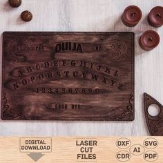 a wooden plaque with the words ouja on it and some other items around it