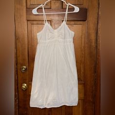 This No Boundaries Spaghetti Strap Sundress Is All White With A Delicate Flower Pattern Throughout. 3 Button Detail On The Front And Scrunch Back With Tie Back Waist. Looks Brand New. Comes From A Smoke Free/ Pet Friendly Home. Garment Has Been Recently Washed And Stored Away From Pets. White Cotton Camisole Dress, White Sundress With Spaghetti Straps For Daywear, White Sundress With Adjustable Straps For Daywear, Daywear Sundress With Spaghetti Straps And Lace Trim, Daywear Sundress With Lace Trim And Spaghetti Straps, Spaghetti Strap Sundress With Lace Trim For Daywear, Spaghetti Strap Sundress With Lace Trim, Poshmark Finds, Delicate Flower