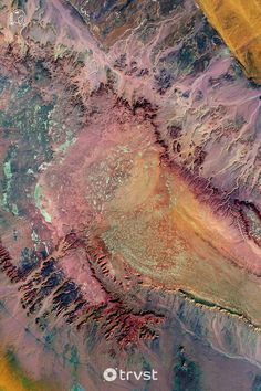 an aerial view of mountains and valleys in the desert