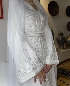 Traditional V-neck Wedding Gown, White Embroidered Dress For Ceremony, Mother Of The Bride Gown With Intricate Embroidery, Ceremony White Dress With Intricate Embroidery, Traditional White Embroidered Wedding Dress, Floral Embroidered V-neck Wedding Gown, Embroidered Floor-length Wedding Dress For Ceremony, Elegant White Gown For Mother Of The Bride, Elegant Embroidered Gown For Mother Of The Bride