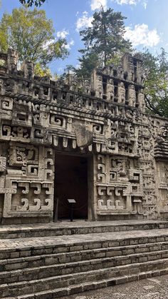 the entrance to an ancient temple with carved carvings on it's walls and steps