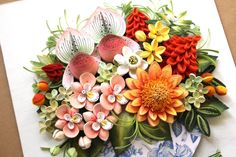 an arrangement of colorful flowers on a plate