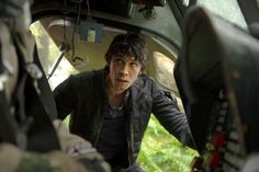 a young man sitting in the back of a car