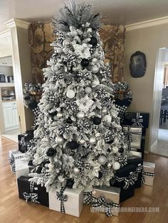 a white christmas tree with black and silver ornaments