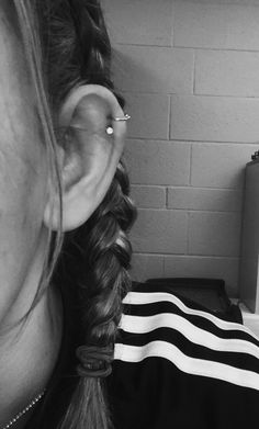 black and white photograph of woman with ear piercing