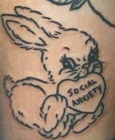 a tattoo with a bunny holding a heart