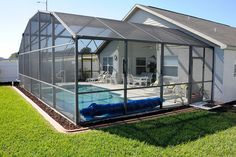 a house with a swimming pool in the back yard and a screened porch on the other side