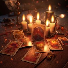 a table topped with cards and candles on top of a wooden table covered in pictures