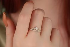 a woman's hand with a diamond ring on it