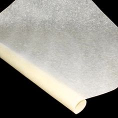 a roll of white paper on a black background