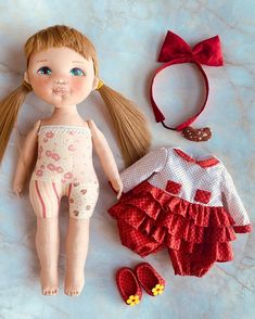 a doll and other items laid out on a marble surface, including a red headband