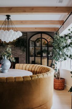 a living room filled with furniture and plants