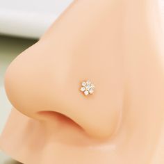 a close up view of a nose with a small flower on it's side