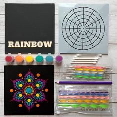 the contents of a rainbow art kit including pens, markers and pencils are laid out on a white wooden surface