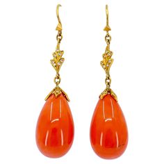 Crafted by designer Cathy Waterman in the 1990s, these Coral drop earrings exude elegance and sophistication. Adorned with 0.08 carats of round brilliant cut diamonds, delicately set in 22k gold, they epitomize timeless luxury. With dimensions of 2.2 inches in length and 0.5 inches in width, these earrings gracefully dangle, catching the light with every movement. Weighing a total of 13.8 grams, they offer a comfortable wear. The vibrant coral adds a pop of color, while the diamonds add a touch Coral Drop Earrings, Cathy Waterman, Timeless Luxury, The 1990s, Gold Drop Earrings, 22k Gold, Round Brilliant Cut Diamond, Round Brilliant, Statement Pieces