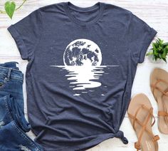 Moon And Sea Shirt, Celestial Moonlight Beach T shirt, Space Lover Gift, Ocean Shirt, Summer Night Tee, Beach Shirt, Birthday gift ideas ooooooooooooooooooo ⚠️Important Note: We offer two different shirt brands for your convenience, Bella Canvas and Gildan Soft Style. If you have a preference for a specific brand, please kindly ask us for availability before placing your order. We want to ensure you get exactly what you love! 📦 Brand Availability: If you do not specify a preference, we will shi Summer Moon Print Crew Neck Shirt, Summer Crew Neck Shirt With Moon Print, Summer Moon Print Relaxed Fit Shirt, Summer Relaxed Fit Moon Print Shirt, Moonlight Beach, Space Lovers Gifts, Ocean Shirt, Beach T Shirt, Space Lovers