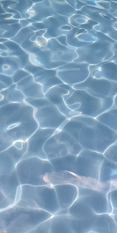 an orange object floating on top of a body of water next to a swimming pool