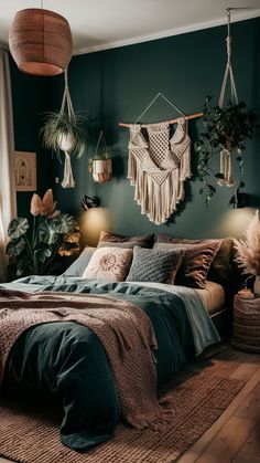 a bedroom decorated in shades of green and brown, with hanging plants on the wall