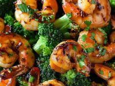 shrimp and broccoli on a plate with sauce drizzled over them